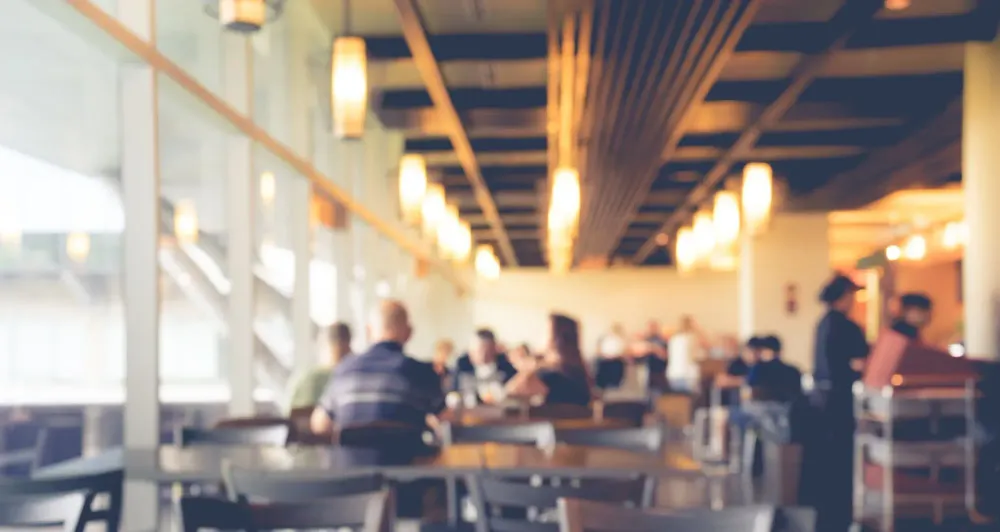 Blurry image of a softly lit airport cafe